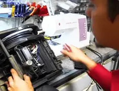Vacuum repair technician servicing internal components on a workbench in West Palm Beach, FL