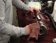 Vacuum repair technician cleaning and servicing a vacuum motor in West Palm Beach, FL
